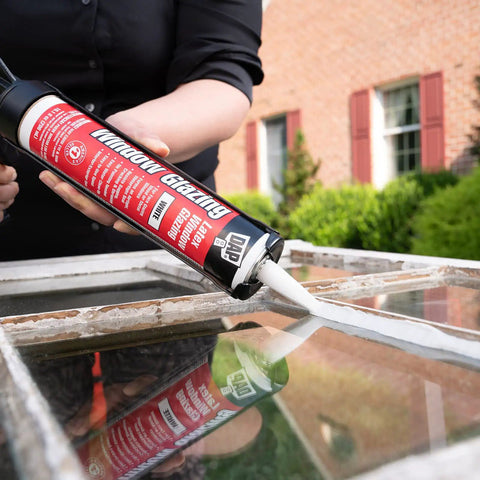 Person applying Latex Window Glazing Sealant White 10.1 Oz for wood and metal window frames to hold glass in place.