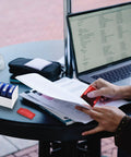 Person using Top Tier Self Inking Office Stamp Set With Eight Gotta Have Rubber Phrases Like Paid And Approved on documents.