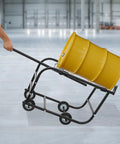 Huge Heavy Duty 55 Gallon Drum Cradle With 600 Lbs Capacity And Retractable Drawbar being used to move a yellow drum.