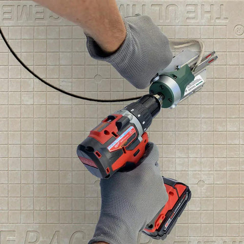 Person using Snapper Shear Pro Drill Attachment For Fiber Cement Board Cutting HardieBacker One Quarter To One Half Inch Thick With Any 18 Volt Or Higher Cordless Drill Contractor Grade For Cutting Any Shape on a cement board