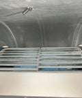 Inside view of Heavy-Duty 61000 BTU Industrial Air Conditioner showing metal grilles and cooling mechanism for garages.