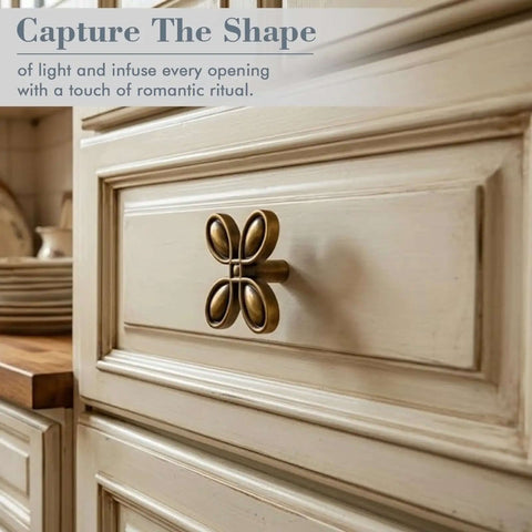 Close-up of Six Pack Butterfly Brass Cabinet Knobs Zinc Alloy Vintage Hardware for cabinets on painted wooden drawer.