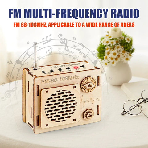 DIY FM Radio Kit For Beginners Build Your Own 88 To 108 MHz Radio Toy featuring wooden speaker box on table.
