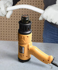 Beast 1800W Hot Air Heat Gun with Dual Temp Modes, shown on a workbench in use for bending PVC pipe by an individual wearing gloves.