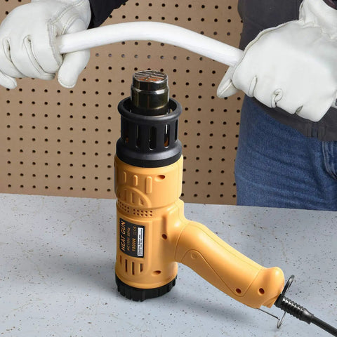 Beast 1800W Hot Air Heat Gun with Dual Temp Modes, shown on a workbench in use for bending PVC pipe by an individual wearing gloves.