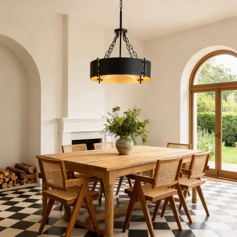 Modern Drum Chandelier With Four Lights In Black And Gold For Dining Room Farmhouse Industrial Pendant Lighting over wooden dining table.