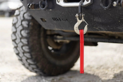 1 Inch Red Reflective Winch Hook Pull Strap With Nylon Core 12 Inch Length Dual Reflective Strips For High Visibility Fits Most Winch Hooks Heavy Duty Recovery Tool attached to a winch hook