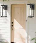 2 Pack 15 Inch Outdoor Wall Sconces With Clear Glass No Fuss Black Finish Weather Resistant Exterior Lanterns For House Garage Doorway Patio Yard With E26 Socket mounted beside a front door.