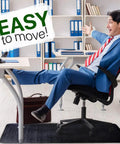 Person reclining on a chair with feet on desk over Massive 53x45 Inch Chair Mat for Hardwood and Tile Floors Black Rolling Desk Mat