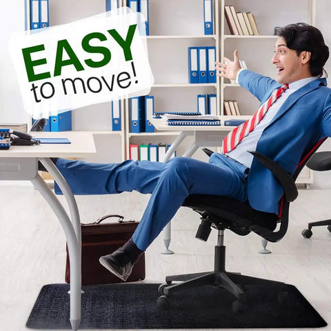 Person reclining on a chair with feet on desk over Massive 53x45 Inch Chair Mat for Hardwood and Tile Floors Black Rolling Desk Mat