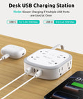 360 Degree Rotating Flat Plug Surge Protector Power Strip With 1 Foot Extension Cord For Tight Behind Furniture Spaces And Heavy Nightstands with USB ports and charging cables on wooden desk.