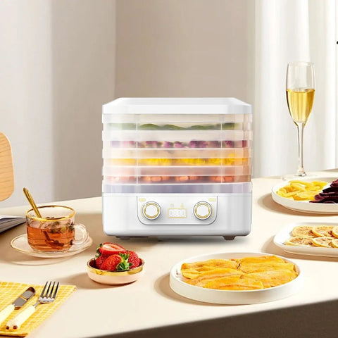 Big League Food Dehydrator Machine With Six Stackable Trays for Candy Snacks Beef Jerky Herbs on kitchen table with fruit.