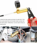 Hands using gold handheld vacuum pump with pressure gauge from Pro Grade Two In One Brake Bleeder Kit for fluid extraction.