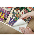 Hands applying Marvel Comics Peel And Stick Wallpaper Mural For Living Room Or Kids Room Ten And A Half Feet By Six Feet Easy To Apply Removable Adhesive Backing No Paste Wall Decor