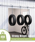 Exterior Sliding Barn Door Hardware Kit With Box Rail Track Supports Up To 450 Pound Capacity installed on wall with hanging tires