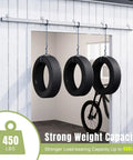 Exterior Sliding Barn Door Hardware Kit With Box Rail Track 450Lb Capacity shown outdoor holding tires