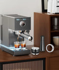 Espresso machine with 58mm Espresso Accessories Kit including distributor, tamper, and WDT tool on wooden counter.