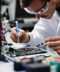 Technician using Four Piece Ceramic Screwdriver Set With Non Conductive Slotted Tips And Anti Static Plastic Build For Safe Electronics Work.