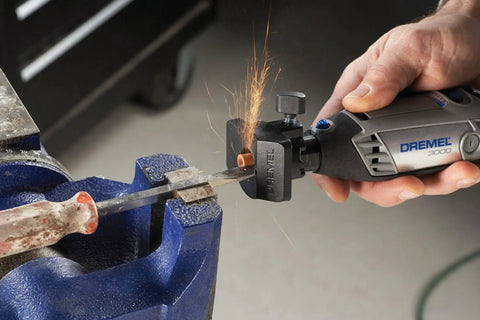 Variable Speed Corded Rotary Tool Kit cutting metal with 1 attachment, sparks flying, close-up view in workshop setting