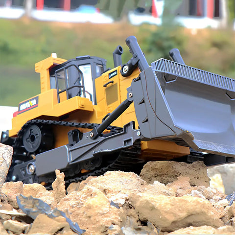 Proportional One Sixteenth Scale RC Bulldozer Toy With Four Wheel Drive Front Loader Metal Shovel on rocky terrain