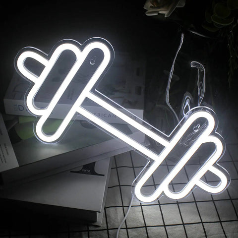 Barbell And Dumbbell Neon Sign For Home Gym Decor LED Neon Lights wall art glowing on a table, sporty vibe for fitness lovers.