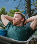 Person relaxing in a Neolite Single Camping Hammock Ultra Lightweight Portable Nylon Parachute Hammock For Backpacking in nature