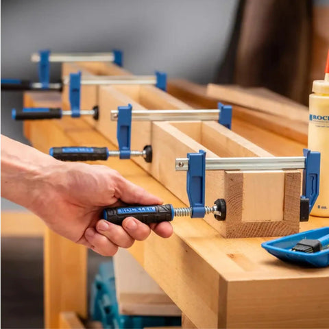 4 Inch Mini F Style Woodworking Clamps Pack Of 4 Beefy Heavy Duty Small Bar Clamps with Sure Foot Base in use on workbench