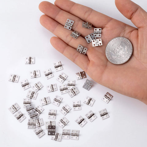 Miniature Jewelry Box Hinges for Crafts 20 Sets Metal Butt Hinges 10.3x8.1mm with Screws shown in a hand with a coin for scale