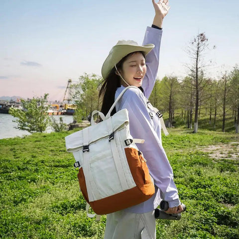 Person wearing Go To Lightweight Waterproof Backpack For Everyday Adventure in grassy field