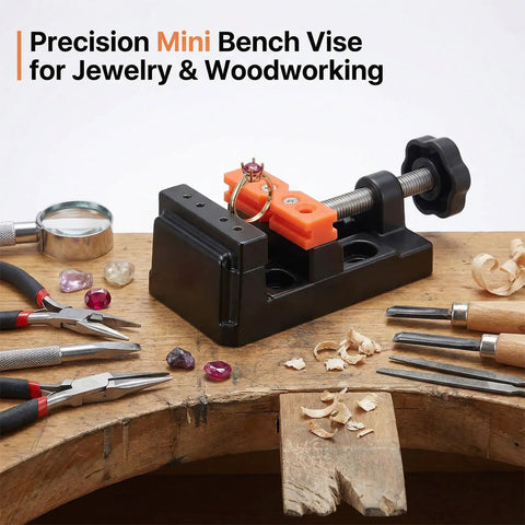 Compact Mini Bench Vise Featuring Smooth Parallel Jaw Clamping For Precision Watch Repair Sculpture Diy Carving And Home Shop Projects Built Different Heavy Duty on wooden workbench with jewelry items.