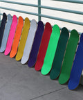 Colorful skateboard decks lined up; Skateboard Grip Tape Sheet 9 By 33 Inches Blue 80 Grit Easy Apply Adhesive Fits Most Skateboards Cruisers