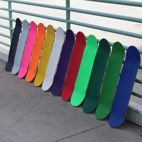 Colorful skateboard decks lined up; Skateboard Grip Tape Sheet 9 By 33 Inches Blue 80 Grit Easy Apply Adhesive Fits Most Skateboards Cruisers