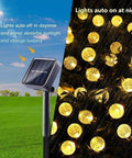 Solar String Lights Outdoor Waterproof 56ft 100 LED Globe Lights With 8 Modes Auto On Off Warm White in garden setting