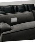 Grey self adhesive linen repair patch kit, 5 pieces, applied to dark upholstery for quick fabric fixes on furniture surfaces.