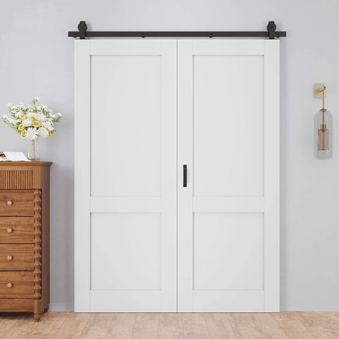 48 By 80 Inch Bifold Barn Door With 64 Inch Track Hardware Two Lite White Primed MDF Panels One And Three Eighths Inch Thick Solid Core Sound Insulated Pre Drilled Space Saving Sliding Door For Laundry Room Or Bedroom displayed installed against a white wall with wooden furniture beside