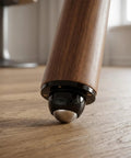 Premium Self Adhesive Caster Wheels For Furniture Legs Featuring A Rock Solid 360 Degree Low Profile Swivel Design Made From Heavy Duty Abs And Brushed Stainless Steel In Matte Black on a wood floor.