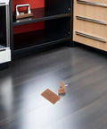 20 Piece Drawer Glide Stopper Set for Tables and Dressers on floor with brown plastic and iron tack-in sliders.