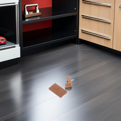 20 Piece Drawer Glide Stopper Set for Tables and Dressers on floor with brown plastic and iron tack-in sliders.