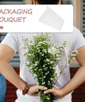 Man holding flowers with "Packaging Bouquet" label, featuring 50 Sheets White Solid Color Folding Tissue Paper for Flower Wrapping.