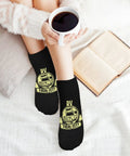 Person wearing Are We There Yet Ankle Socks Five Pair Pack Moisture Wicking Athletic Socks For Running And Gym; coffee and book visible