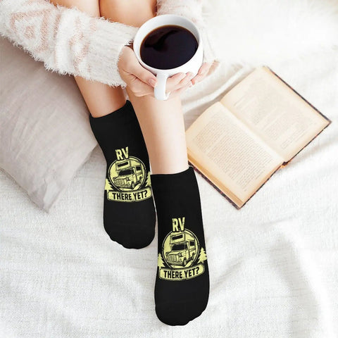 Person wearing Are We There Yet Ankle Socks Five Pair Pack Moisture Wicking Athletic Socks For Running And Gym; coffee and book visible