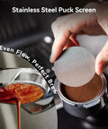 Stainless steel puck screen being placed over espresso for even flow and perfect brew, level up your home cafe setup with this premium 58mm espresso tamper and coffee distributor bundle including a sharp WDT tool for even distribution and nailed every single pull.