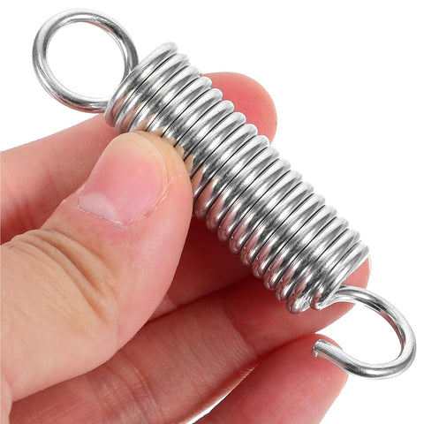 Close-up of a stainless steel spring from Extended Tension Springs 10 Pack Stainless Steel Small Compression Springs For Gates And Doors Universal Fit Heavy Duty Durable Kit For Cabinets Fences And More.