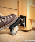 Foot engaging pin-release mechanism on quick-release workbench caster plate, showcasing smooth lateral release and hardware assembly