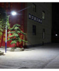 Hella Bright Solar Led Flood Light With Remote Control for Outdoor Yard and Garden IP65 waterproof illuminating a pathway at night.