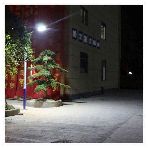 Hella Bright Solar Led Flood Light With Remote Control for Outdoor Yard and Garden IP65 waterproof illuminating a pathway at night.