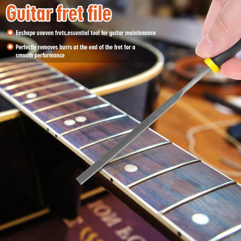 Angled view of a guitar fret end dressing file on a wooden fretboard; gray metal file with black and yellow handle.