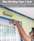 Person applying paint near window using blue painter's tape for walls and crafts, premium masking tape, no residue, easy removal.
