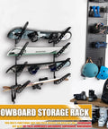 4 Board Snowboard Wall Rack Adjustable Storage for Ski Surfboard Wakeboard Wall Mount Display with Accessory Hooks to Hang Backpacks and Jackets Keep Your Shred Quiver Tidy in the Garage or Living Room Space Saver Black mounted on wall holding snowboards with accessories.