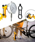 Pro Bike Wheel Truing Stand And Rim Adjustment Tool used for precise spoke alignment during on-bike repairs with cyclist.